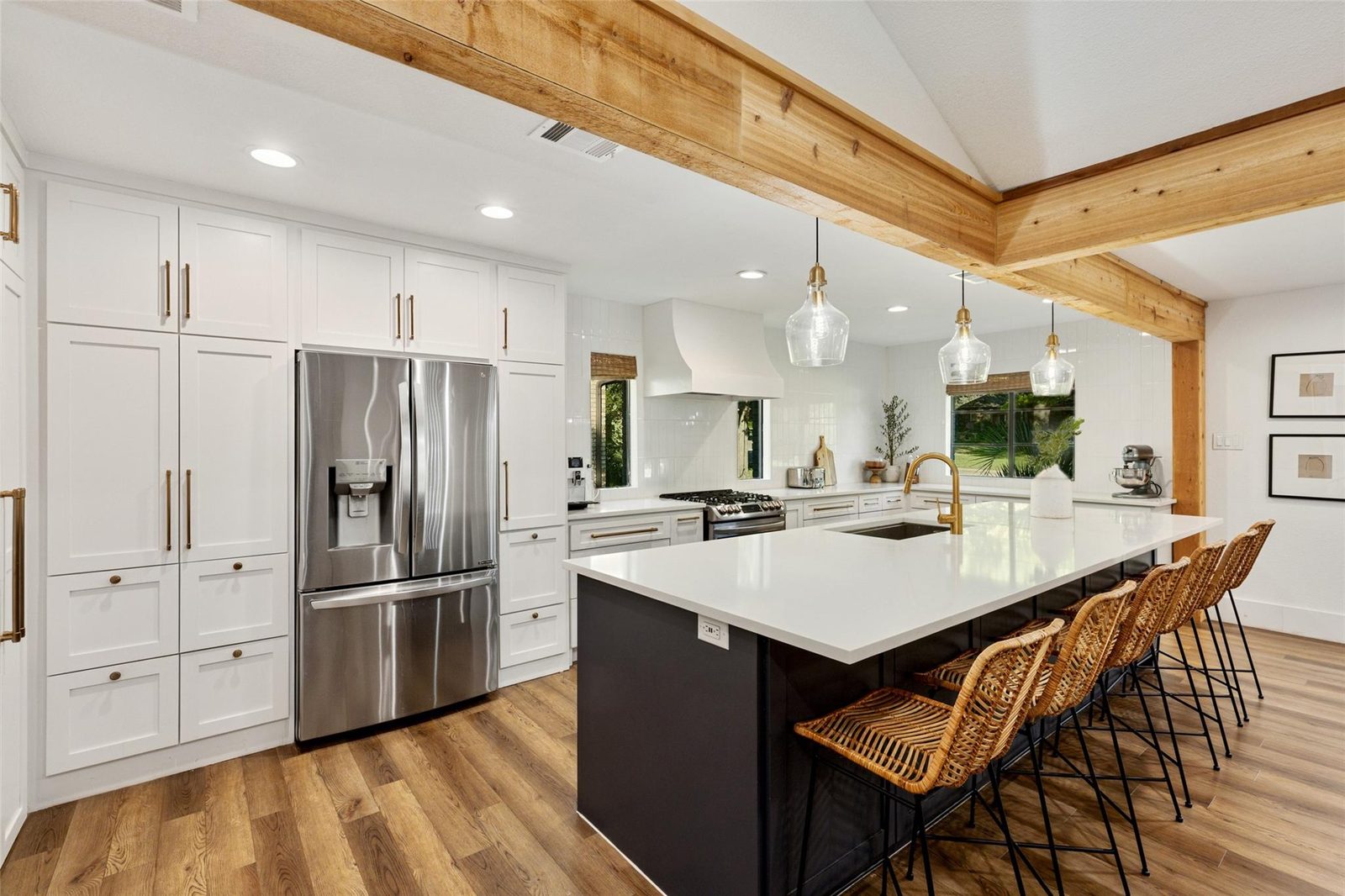 Kitchen after renovation with custom white cabinetry and large island
