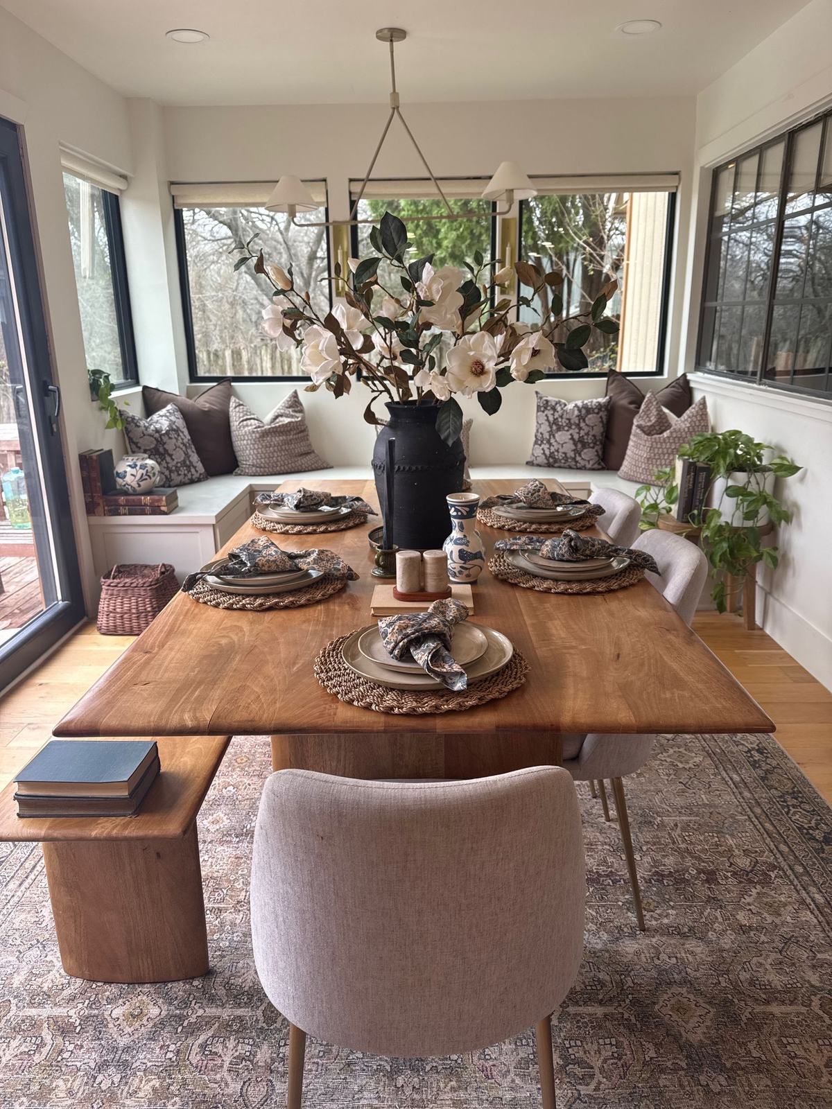 Breakfast nook with a live edge table, built-in banquette and magnolia branches